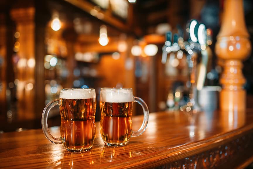 Taffer's Tavern Two beer mugs on wooden bar counter